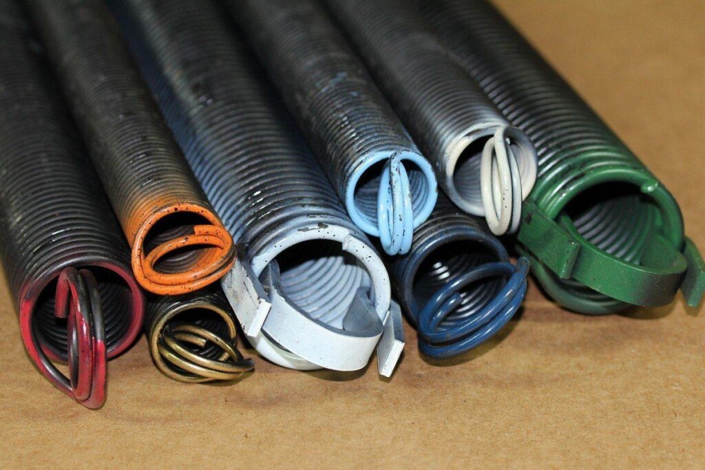 Real assorted garage door extension springs in multiple sizes and colors